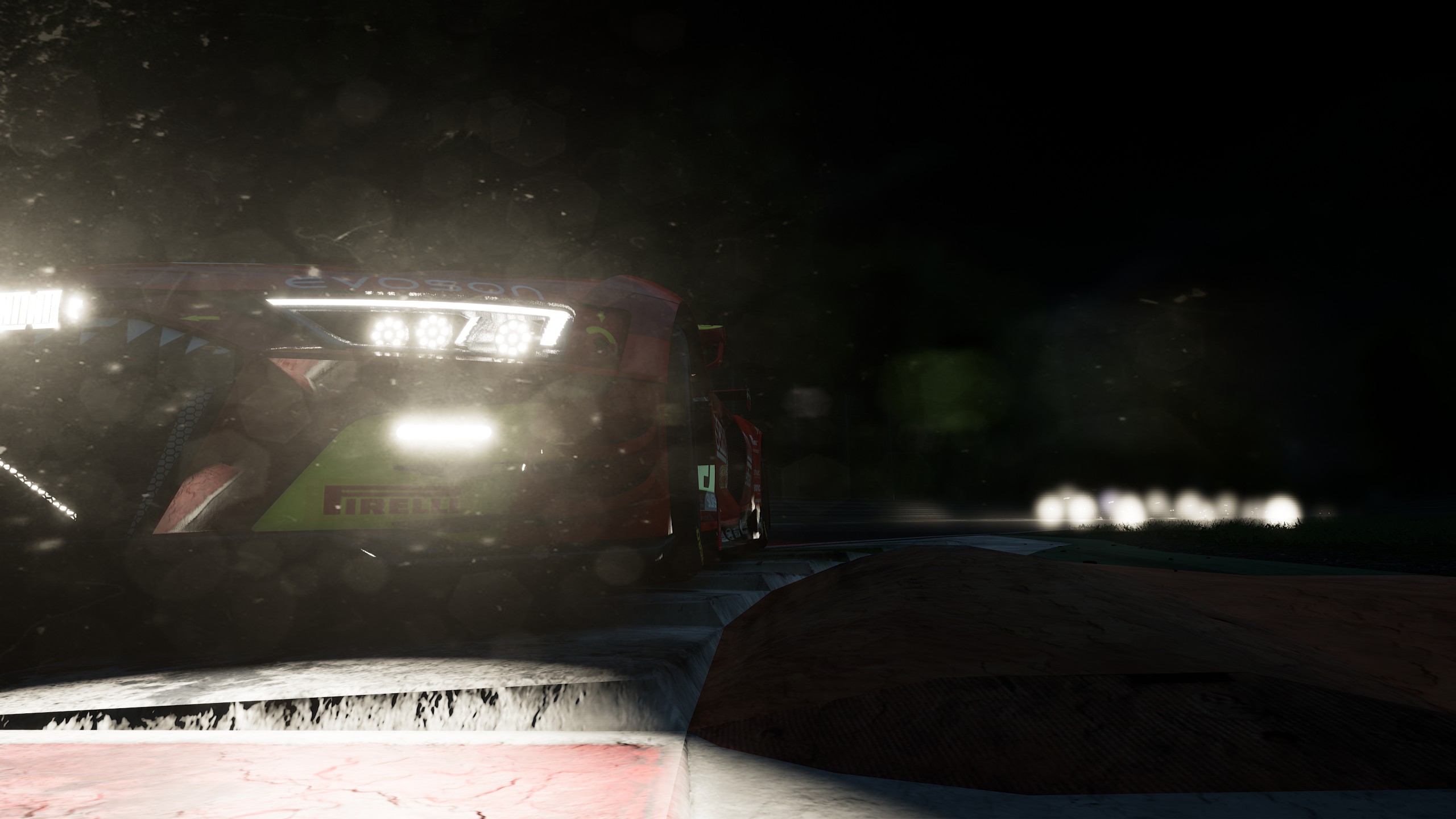 Closeup of red Audi R8 LMS Evo lights in front of other GT3 cars in a curve.